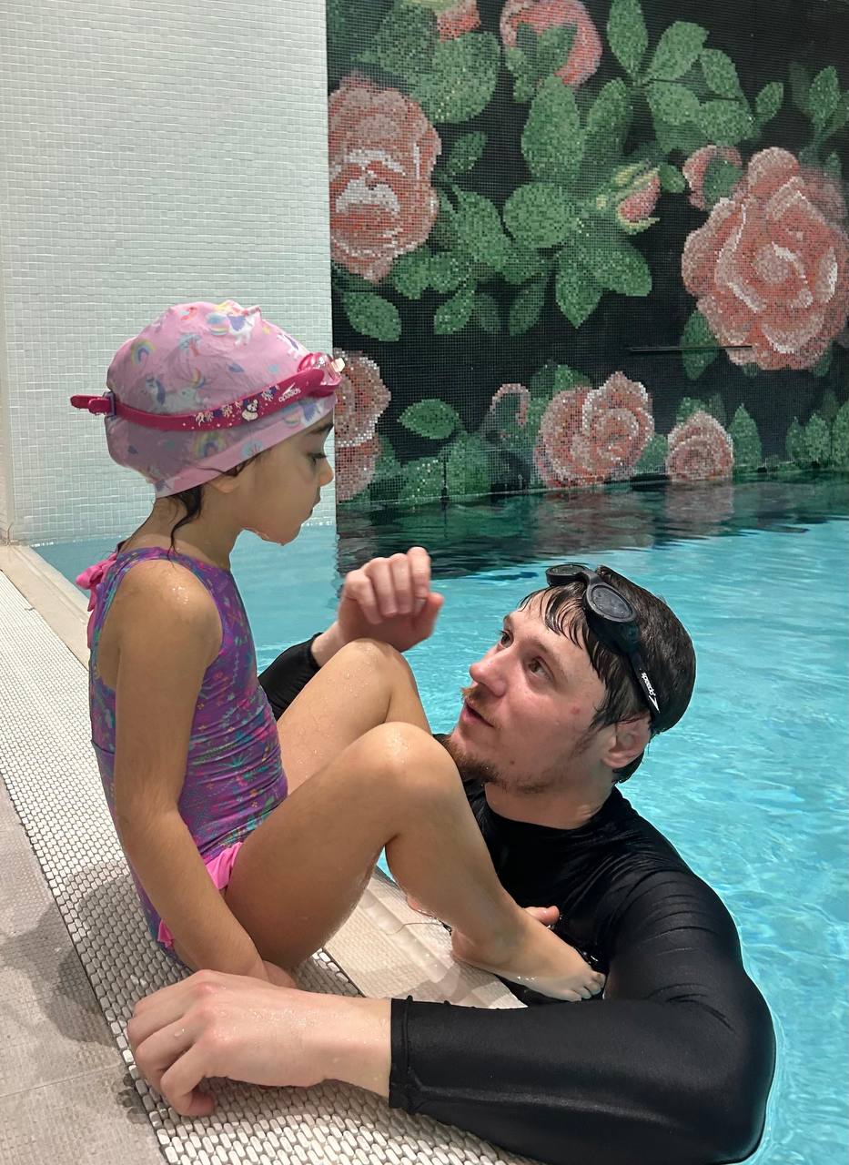 Swimming instructor with child